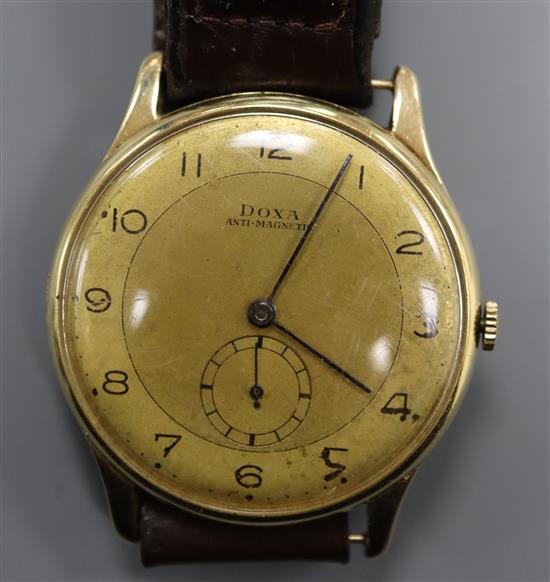 A gentlemans yellow metal Doxa manual wind wrist watch, with subsidiary seconds, on leather strap